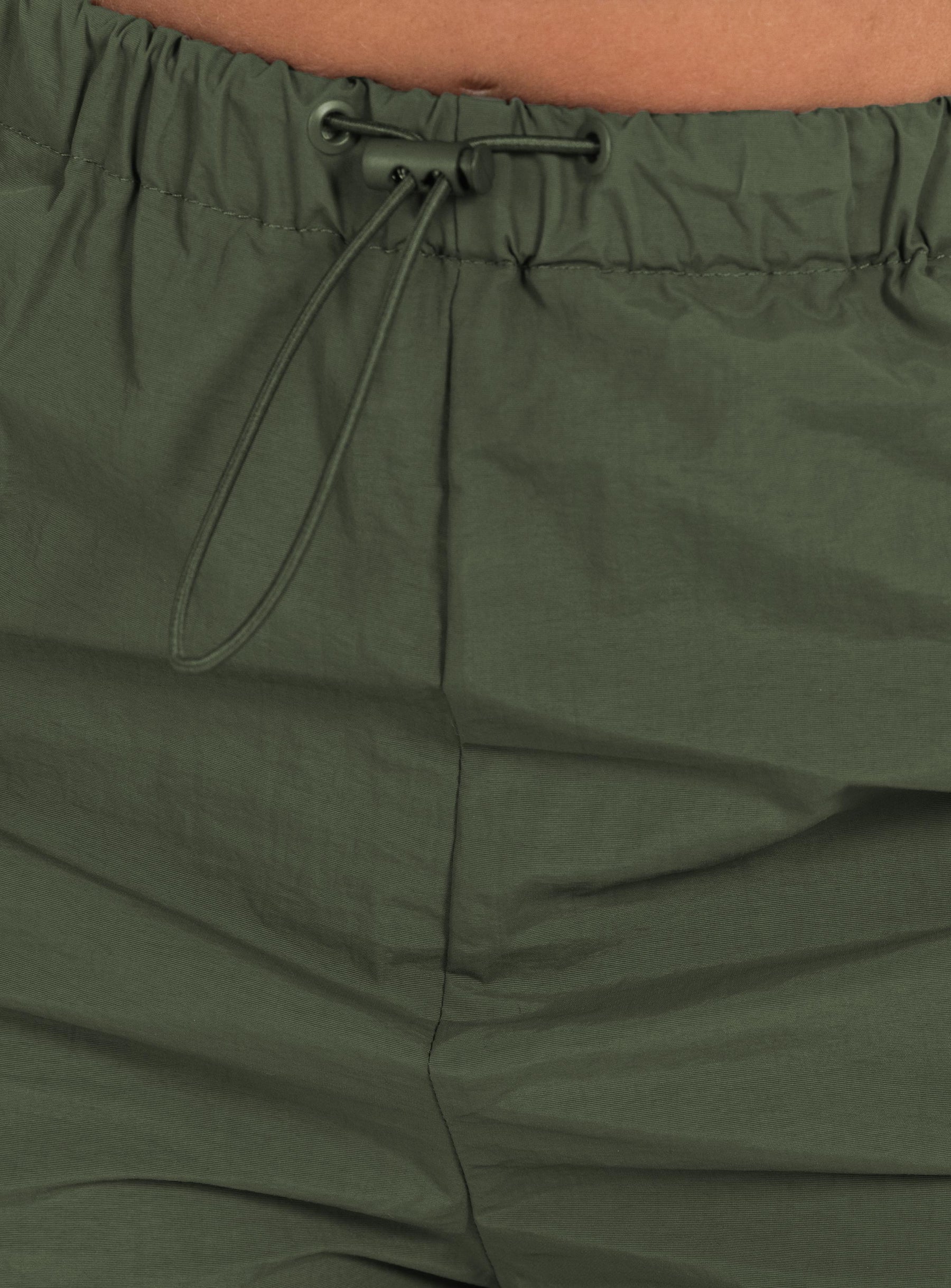 Olive green cargo pants Drawstring waist Twin hip pockets Straight leg Extra cargo style leg pockets Drawstring cuff Non-stretch Unlined