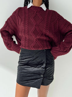 Black mini skirt Quilted material High rise Invisible zip fastening at back Button detail at front