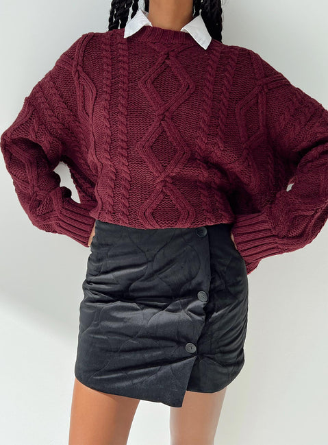 Black mini skirt Quilted material High rise Invisible zip fastening at back Button detail at front