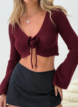 Long Sleeve Top Knit material, V-neckline, crop style rosette detail, flared sleeves, tie fastening at bust